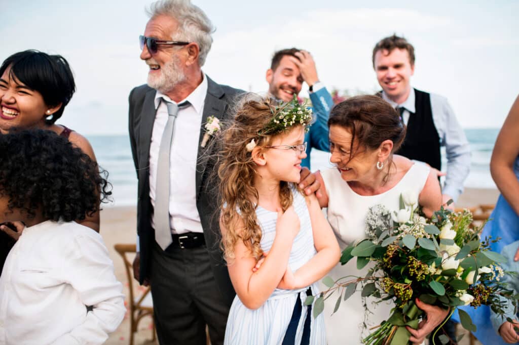 Family attending a beach wedding ceremony