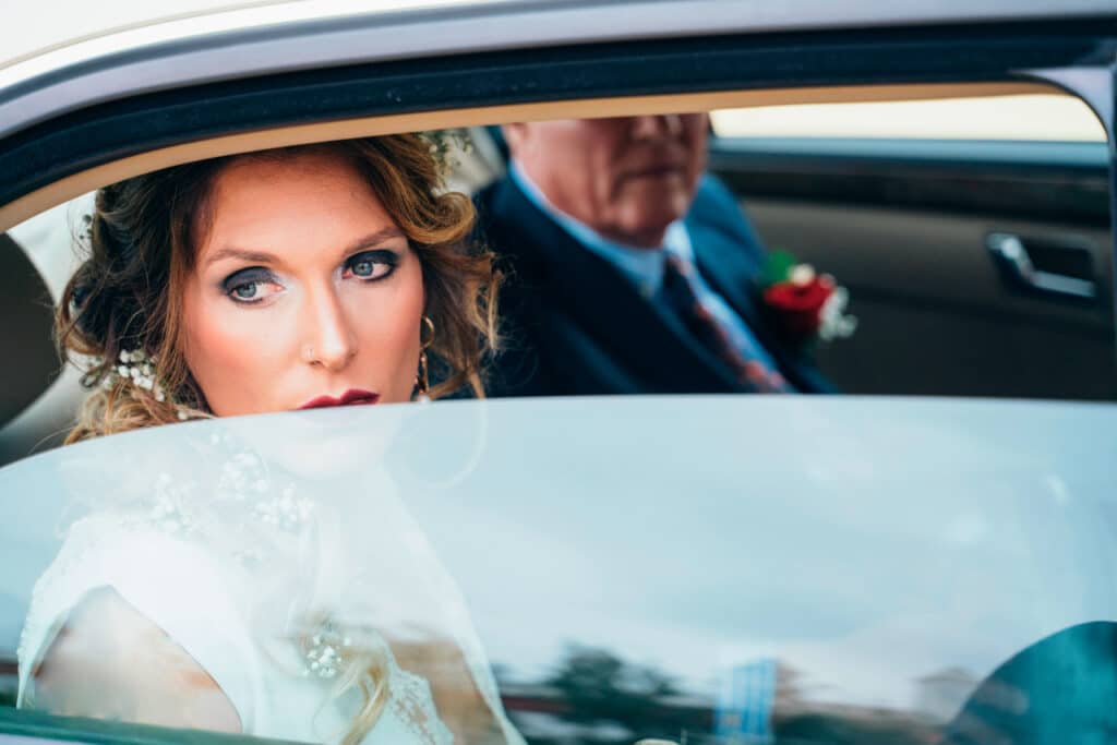 cinematic wedding shot of the bride arriving to the wedding by car.