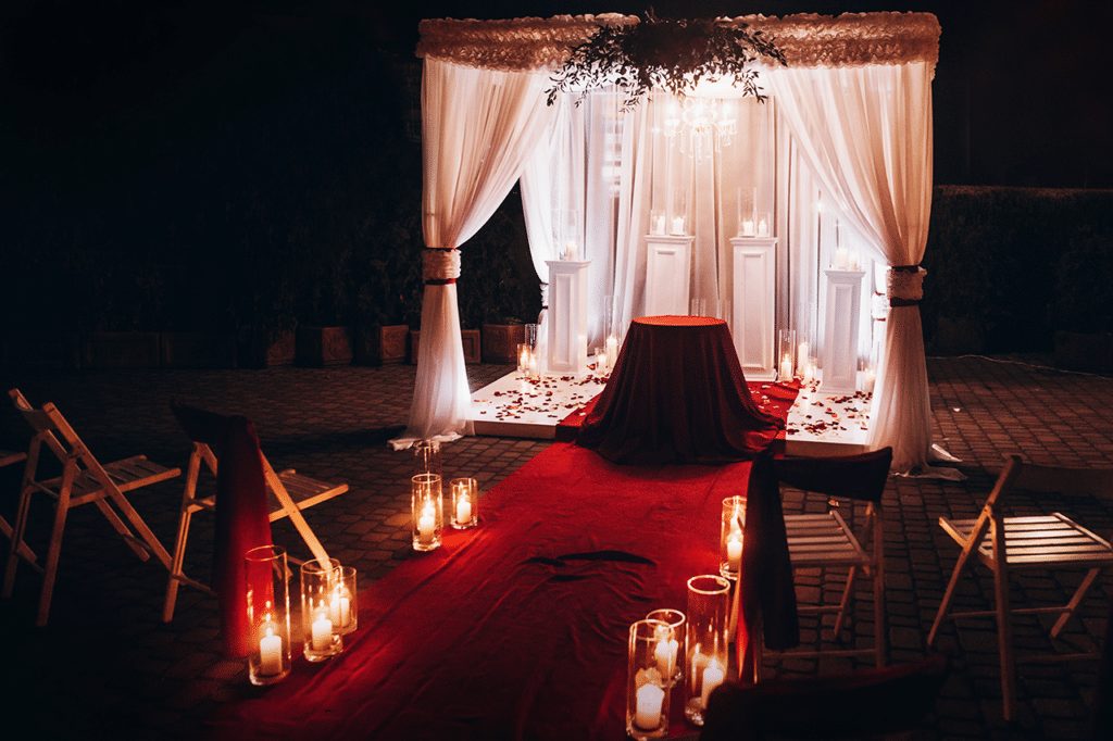 Wedding venue aisle with candles in glass lanterns